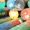 multi colored metal barrels stacked and scattered